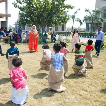 Children doing outdoor activities at Happy's Baby Daycare in Dhaka