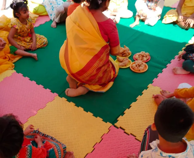 A teacher and children at Happy's Baby Daycare